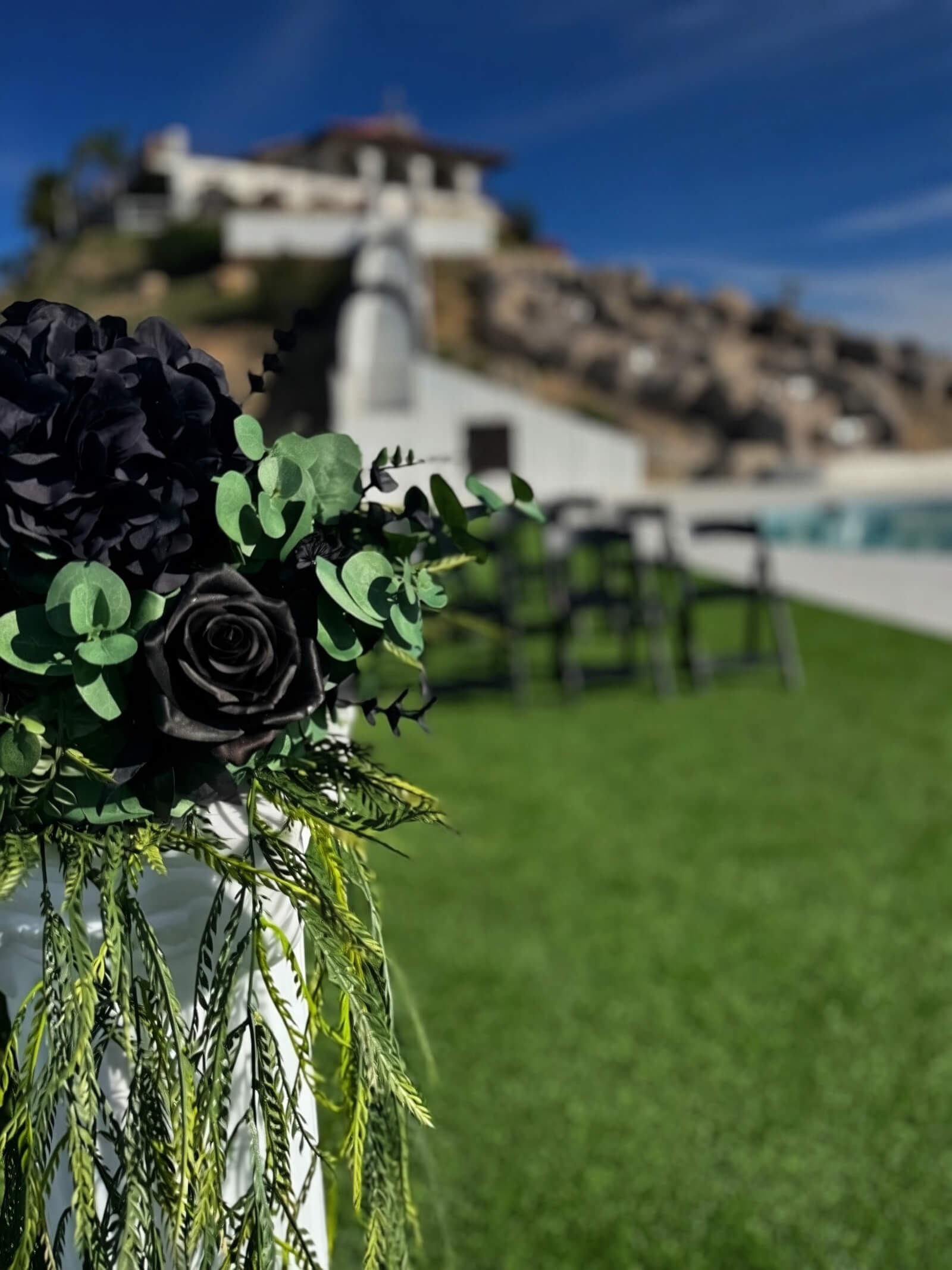 Editorial Black Rose floral pillar at a luxury wedding ceremony