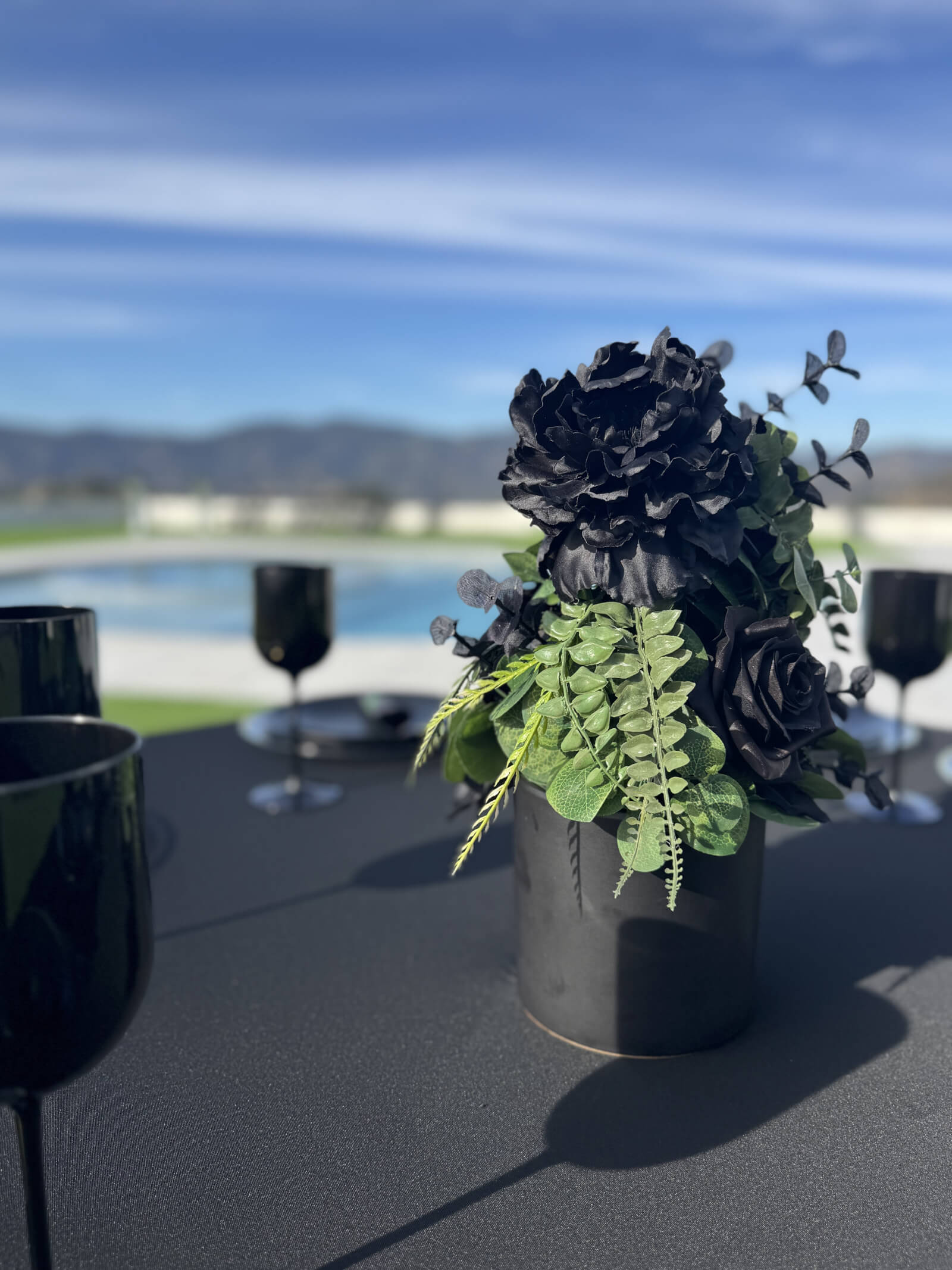 Editorial Black Rose reception table with dramatic dark florals and candlelight