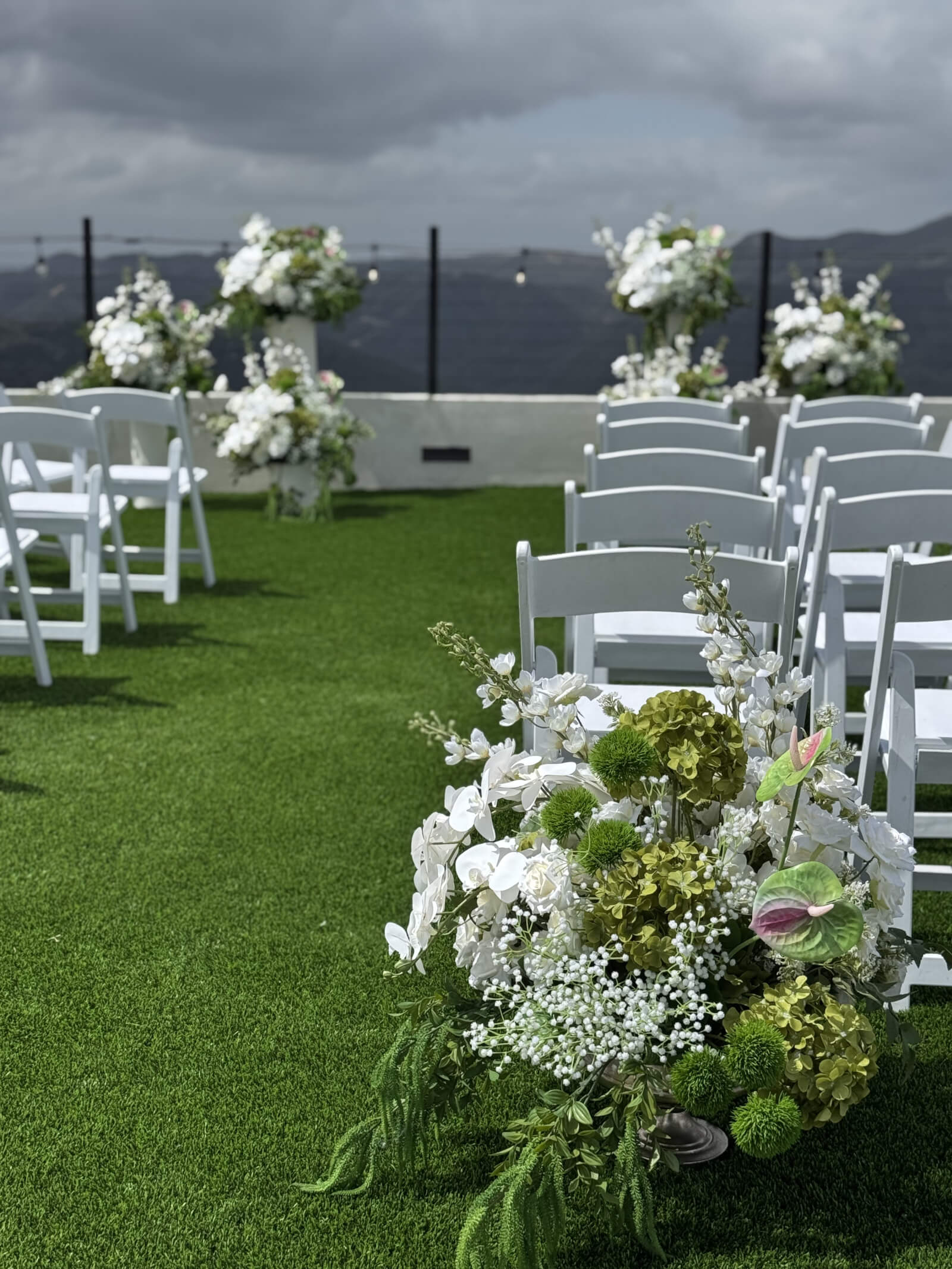 Ceremony arch styled with warm florals at the Farley wedding